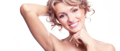 A smiling woman with smooth underarms 