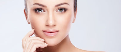A woman with styled eyebrows posing for a photo