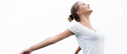 A woman smiling with her arms oustretched